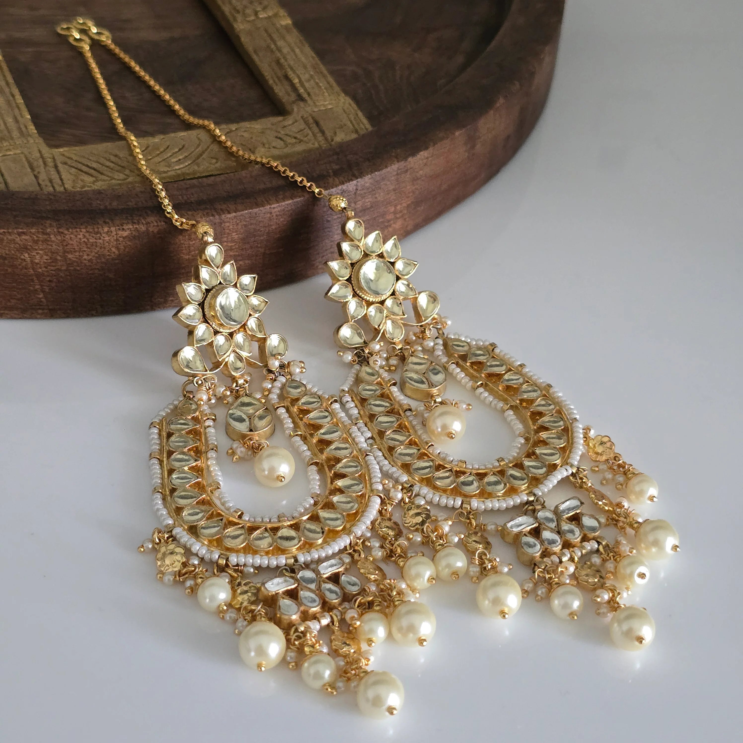 Front view of exquisite gold-plated Kundan and pearl Chandbali earrings, perfect for Indian weddings and festive occasions.