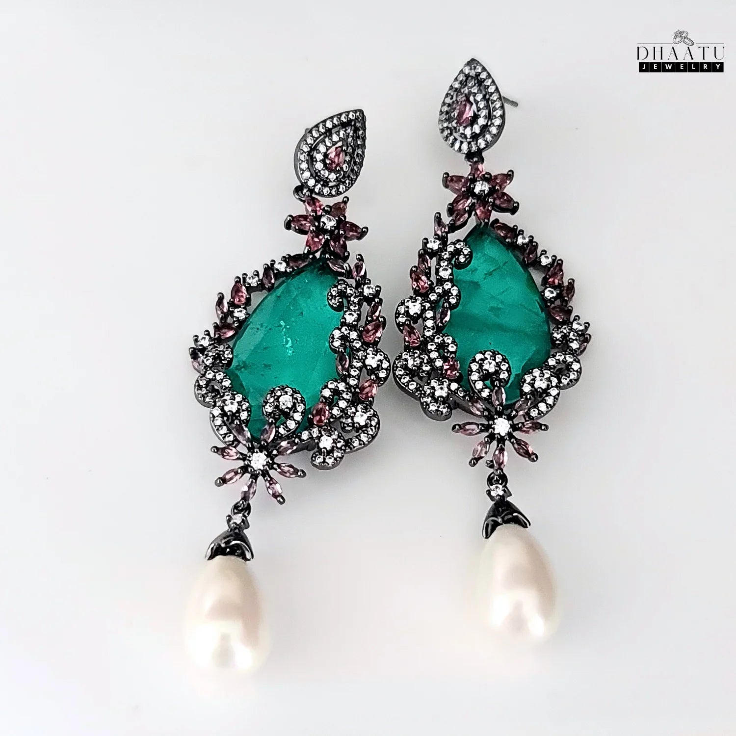 Front view of DHAATU JEWELRY green AD stone and pearl drop earrings on a white background.