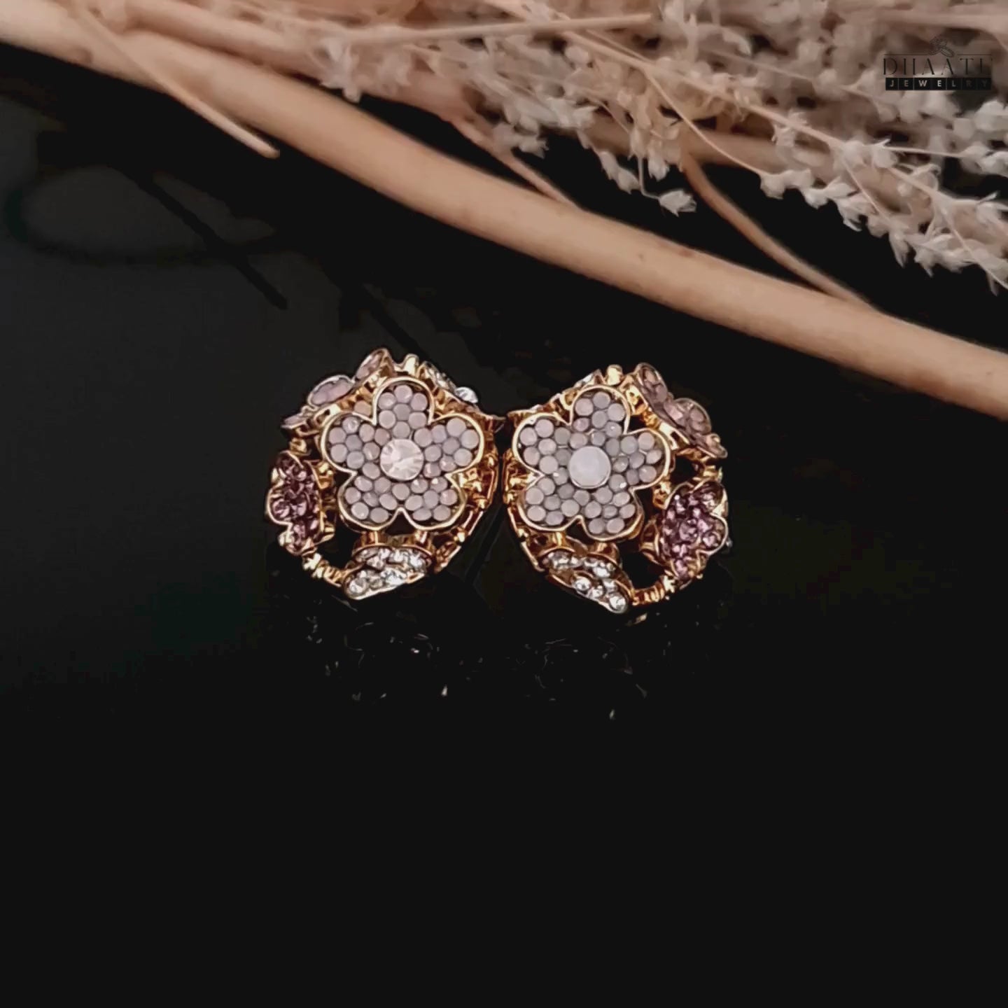 Load video: Detailed 360-degree video of the floral stud earrings highlighting the crystal arrangement.