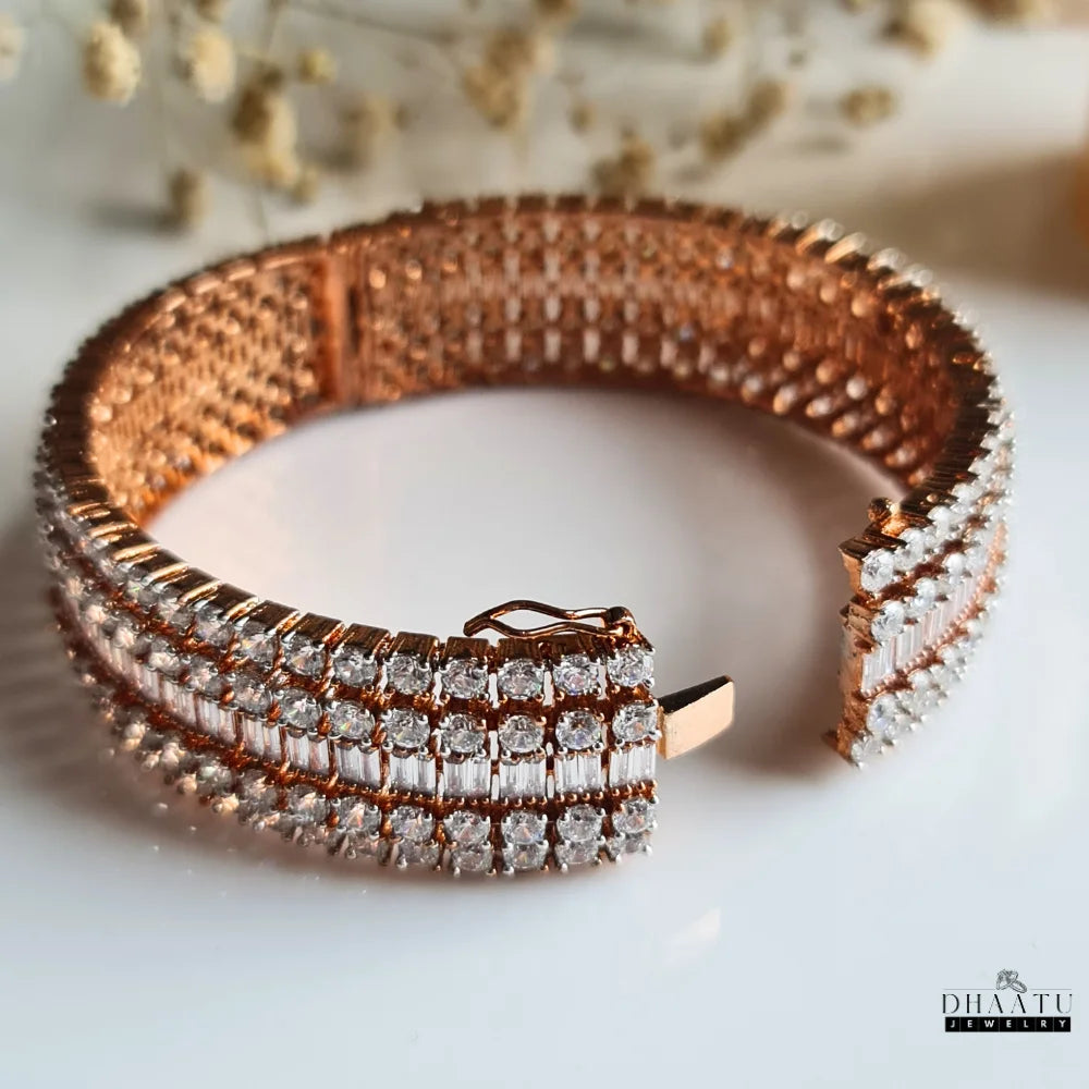Dhaatu Jewelry rose gold plated American Diamond Kada bracelet with its clasp open, showing the secure locking mechanism and inner mesh design.

