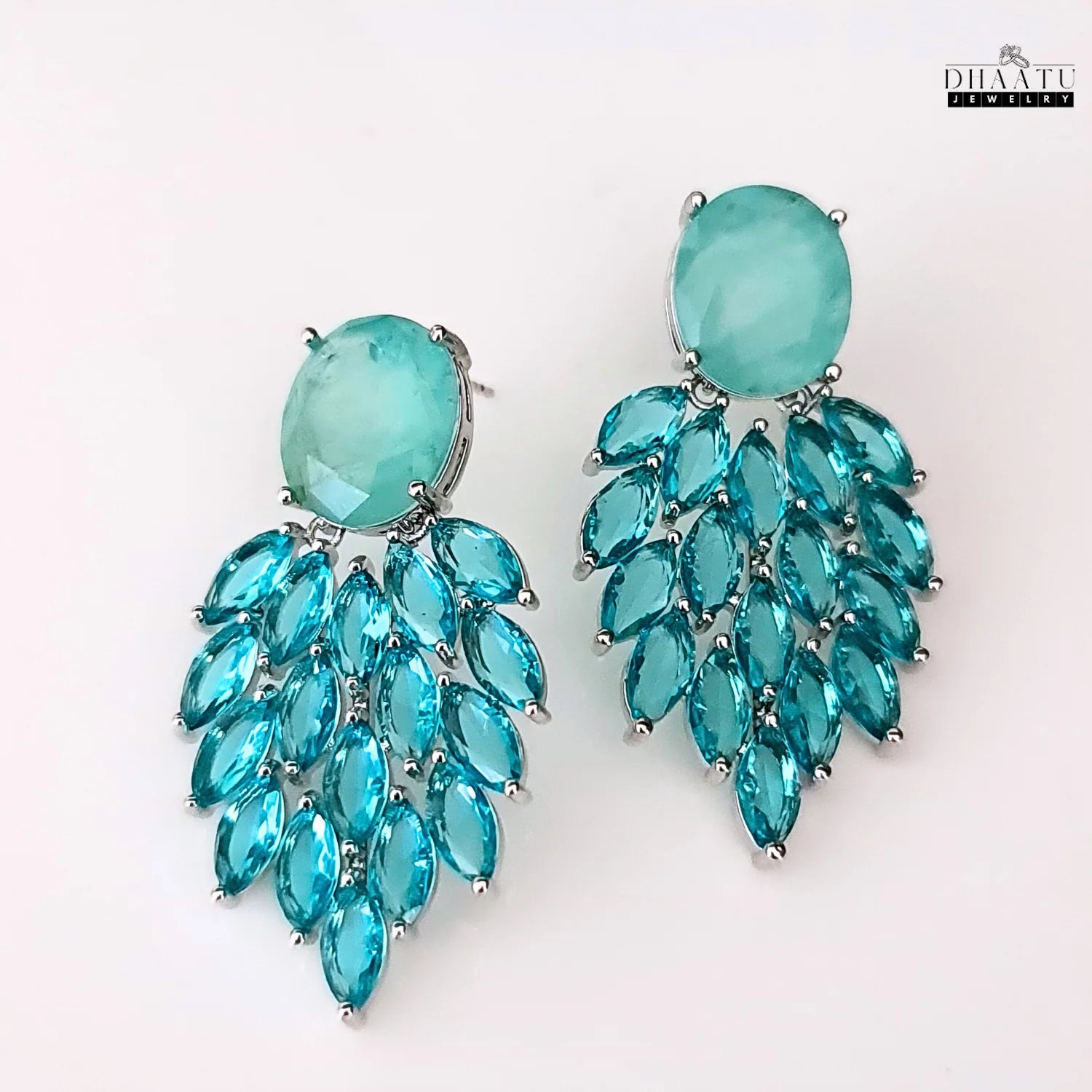 A product shot of the Aqua Chalcedony and marquise cut blue stone dangler earrings against a clean white background, highlighting their elegant design.