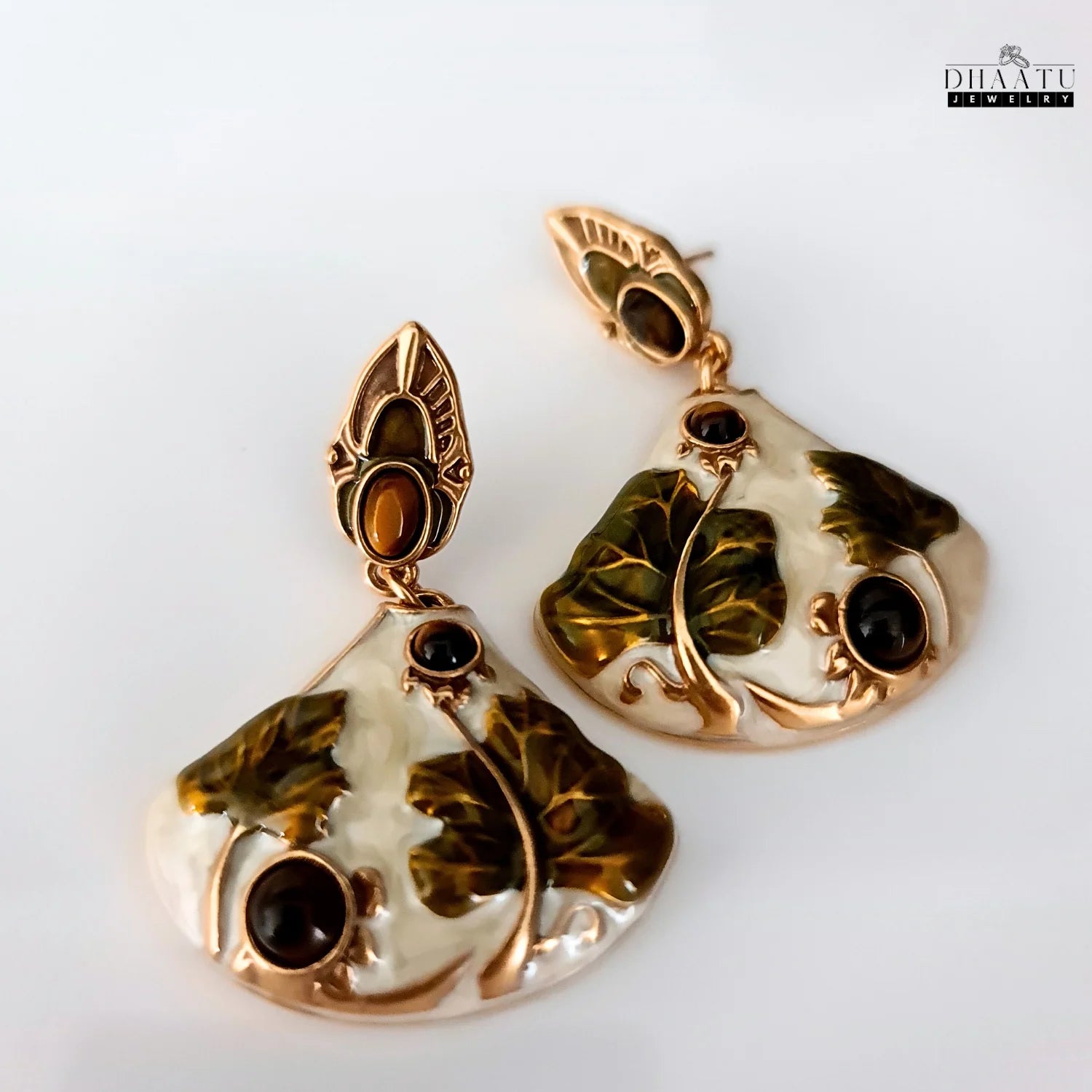 Pair of Art Nouveau lotus drop earrings on a clean white background, showcasing the enameled finish and tiger's eye stones.