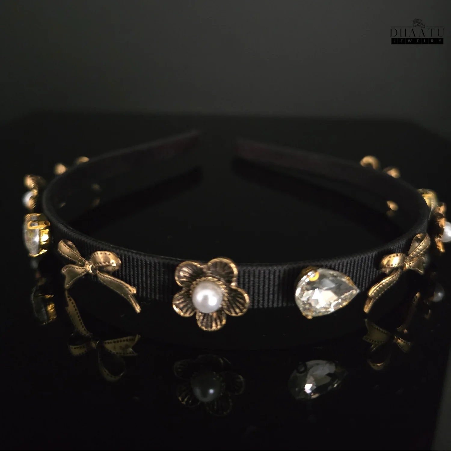Dhaatu Jewelry elegant black ribbon hairband with gold flower and pearl accents, and clear teardrop crystals