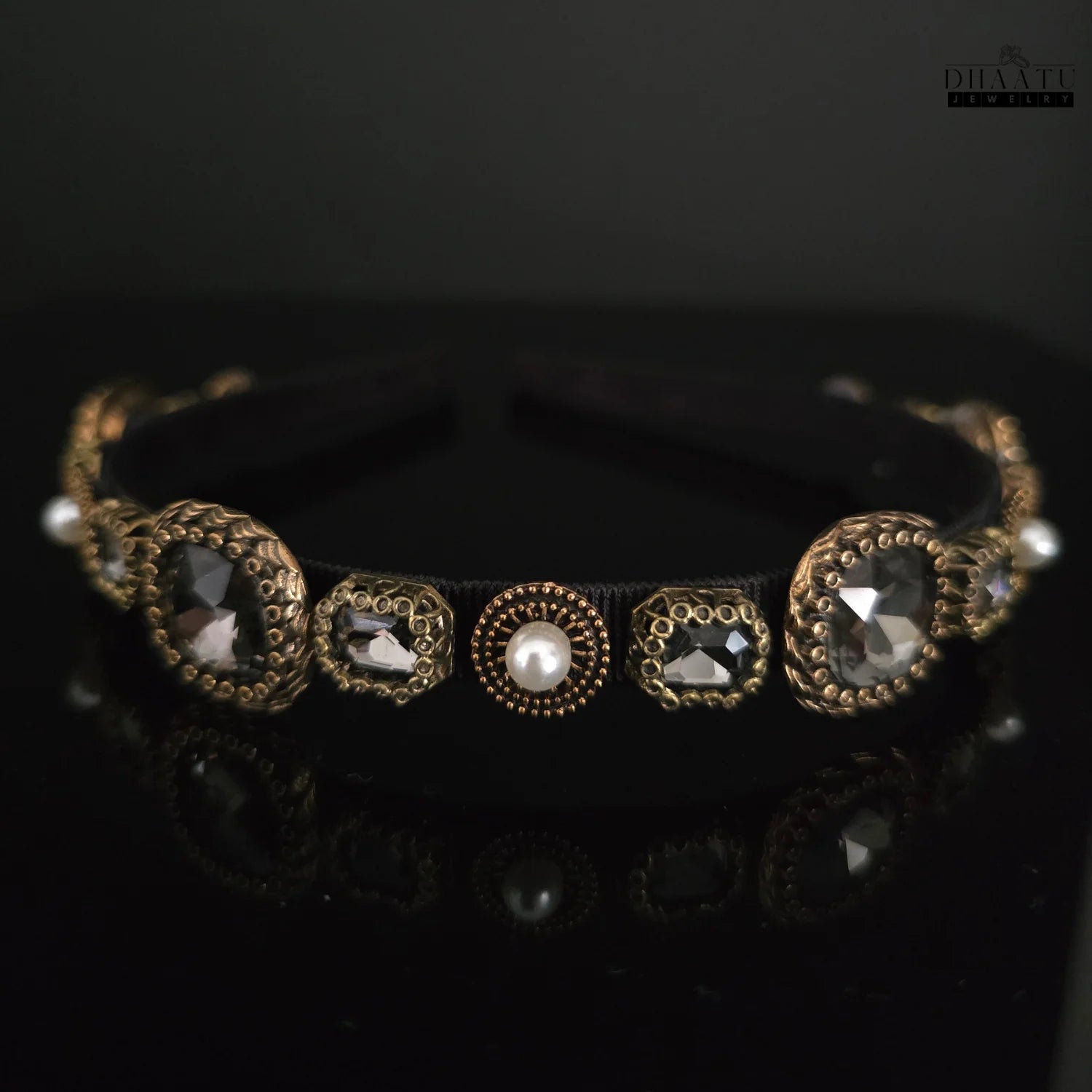 Elegant Dhaatu Jewelry hairband showcasing central pearl and sparkling crystal embellishments