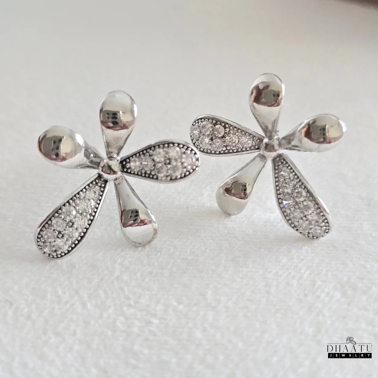 Dhaatu Jewelry silver-plated flower stud earrings with cubic zirconia on a clean white background
