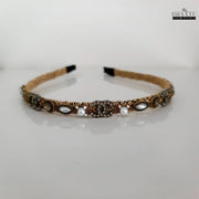 Front view of Dhaatu Jewelry western style golden hairband with pearl and crystal embellishments on a clean white background
