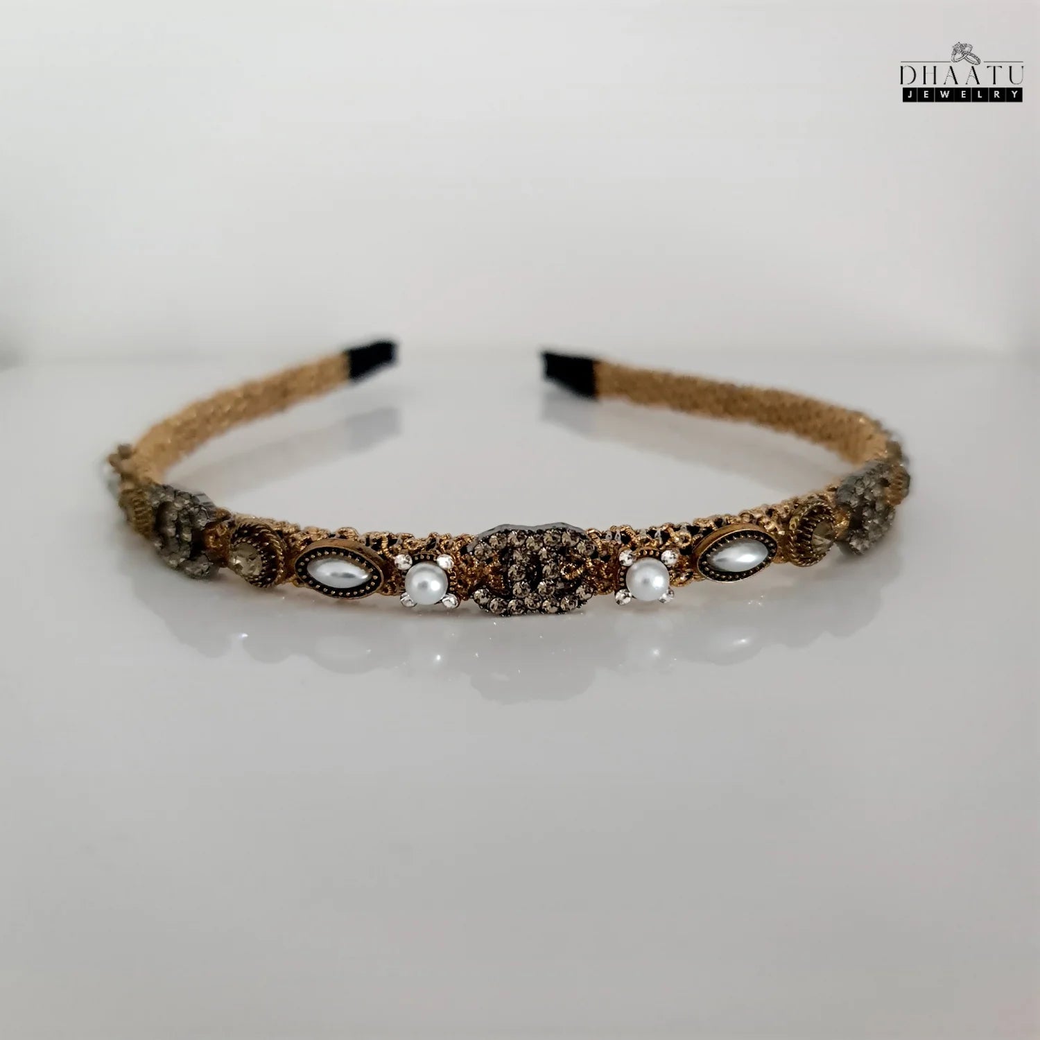 Front view of Dhaatu Jewelry western style golden hairband with pearl and crystal embellishments on a clean white background