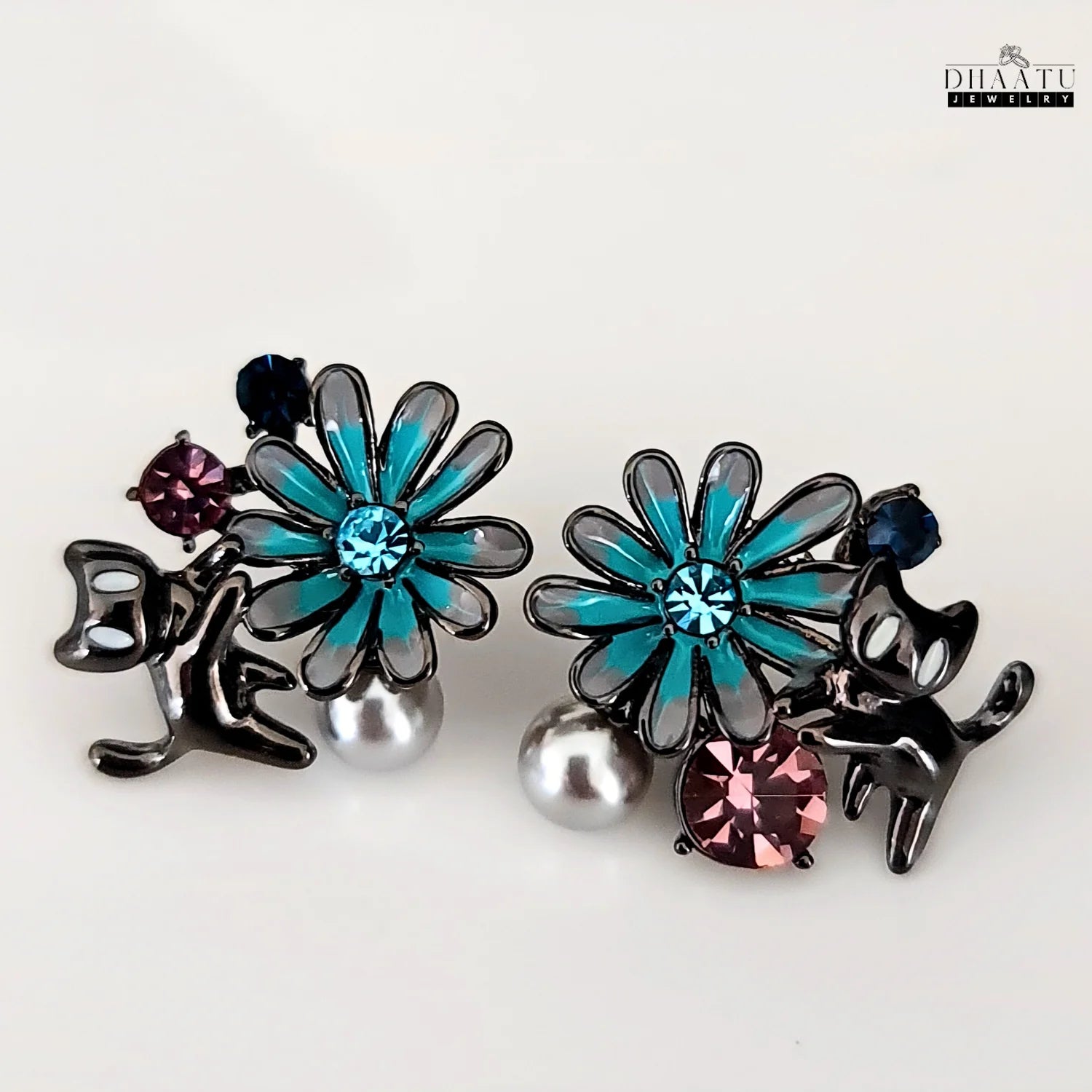 The gunmetal cat and floral earrings on a clean white background, showing the full design and arrangement of the elements.