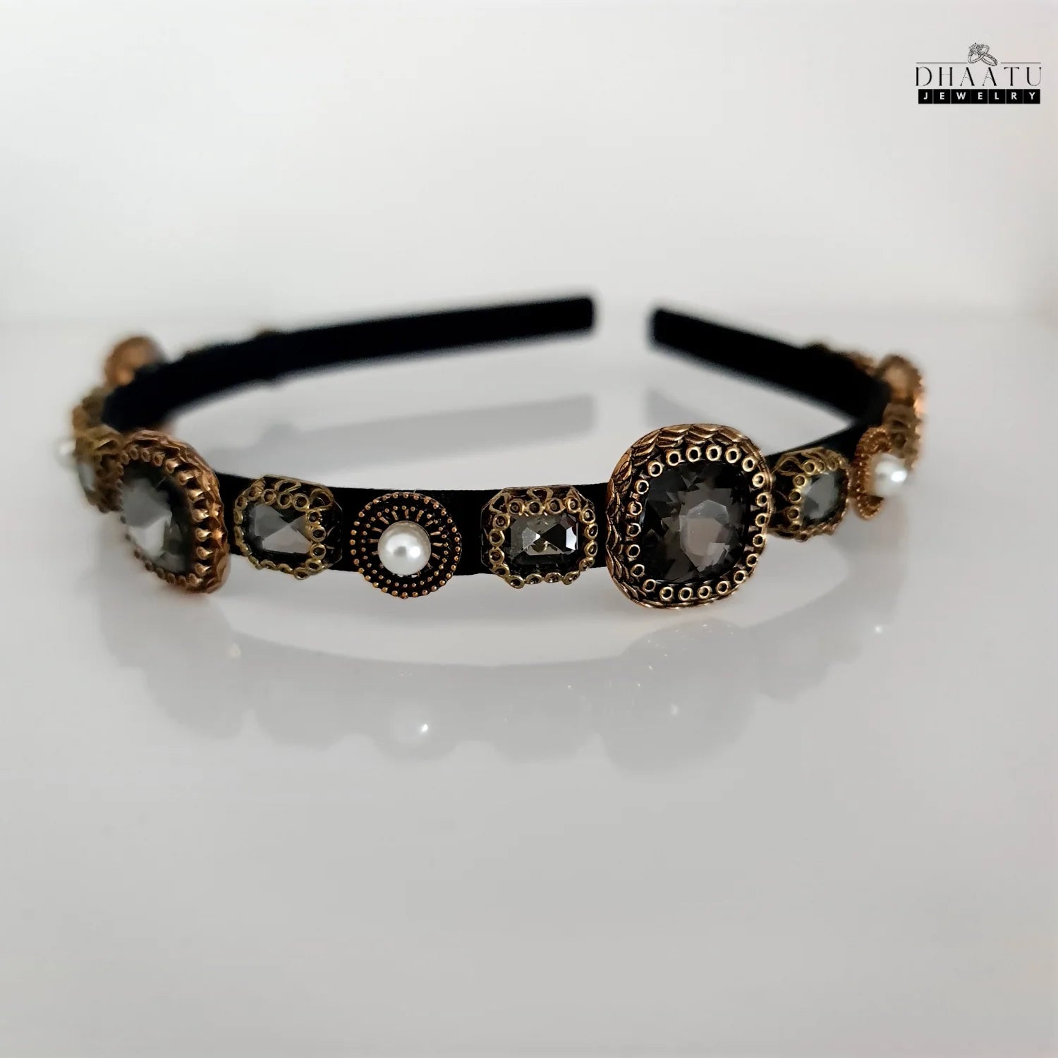 Front view of modern Dhaatu Jewelry bejeweled hairband on a white background