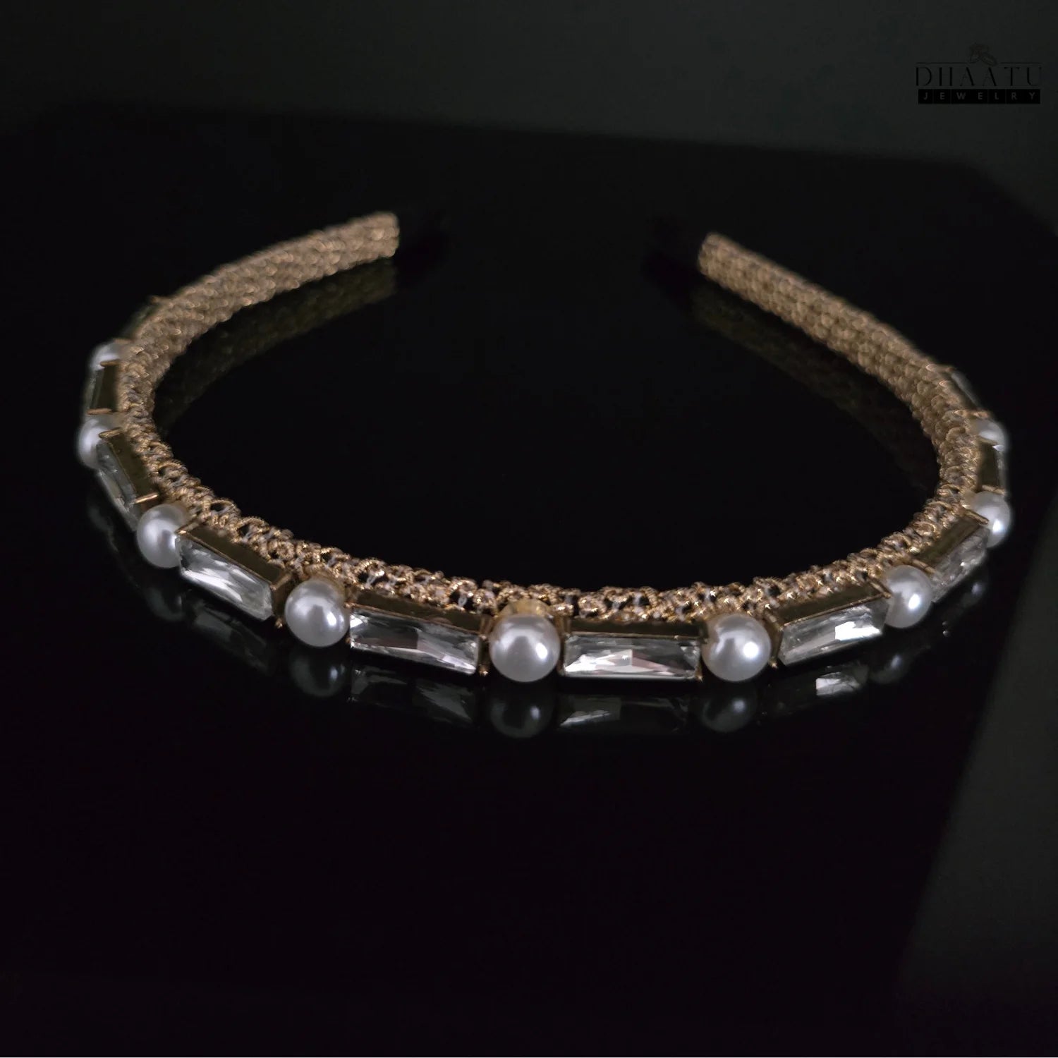 Close-up view of elegant gold hairband with pearls and baguette crystals, ideal for modern western fashion