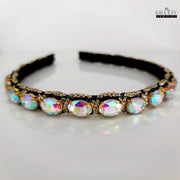 Modern Western headband with vibrant iridescent crystals and golden woven details, presented on a white background