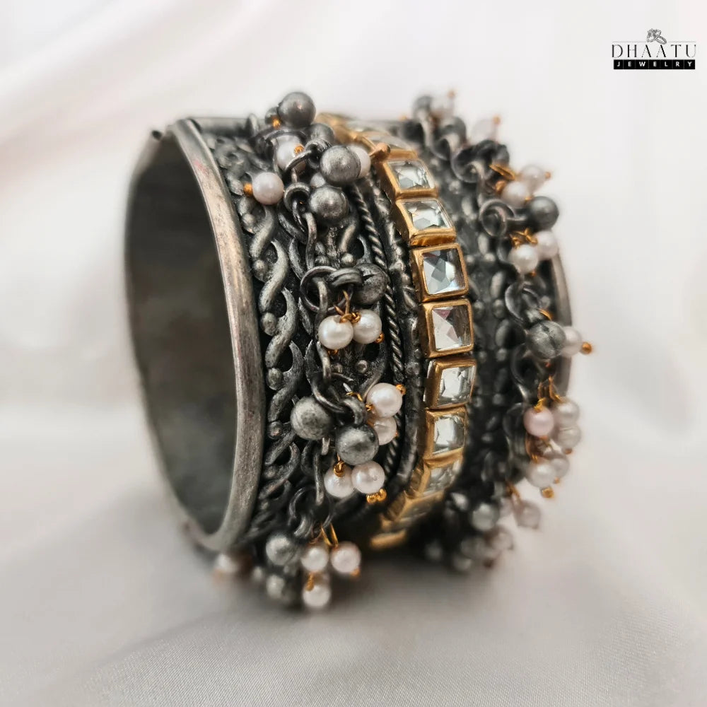 Side profile of adjustable oxidized silver-plated cuff bracelet showcasing design depth