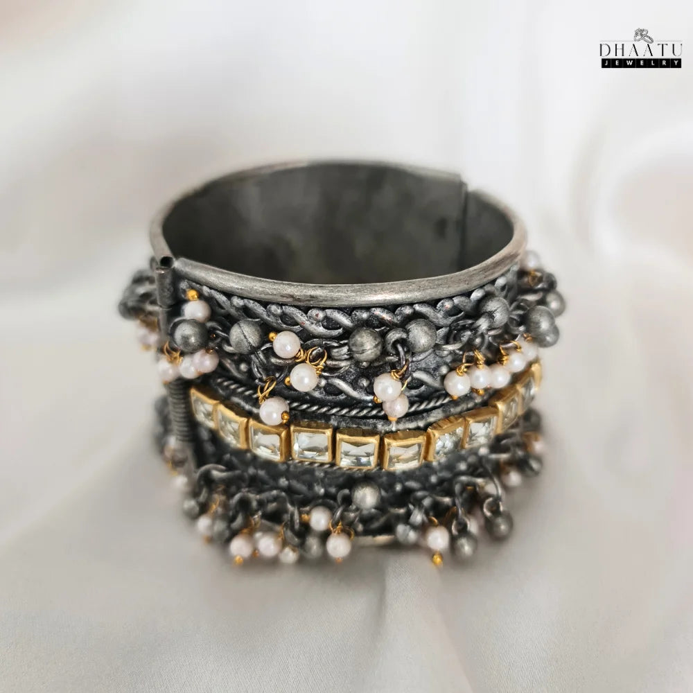Detailed view of Kundan and oxidized silver design on an adjustable bracelet