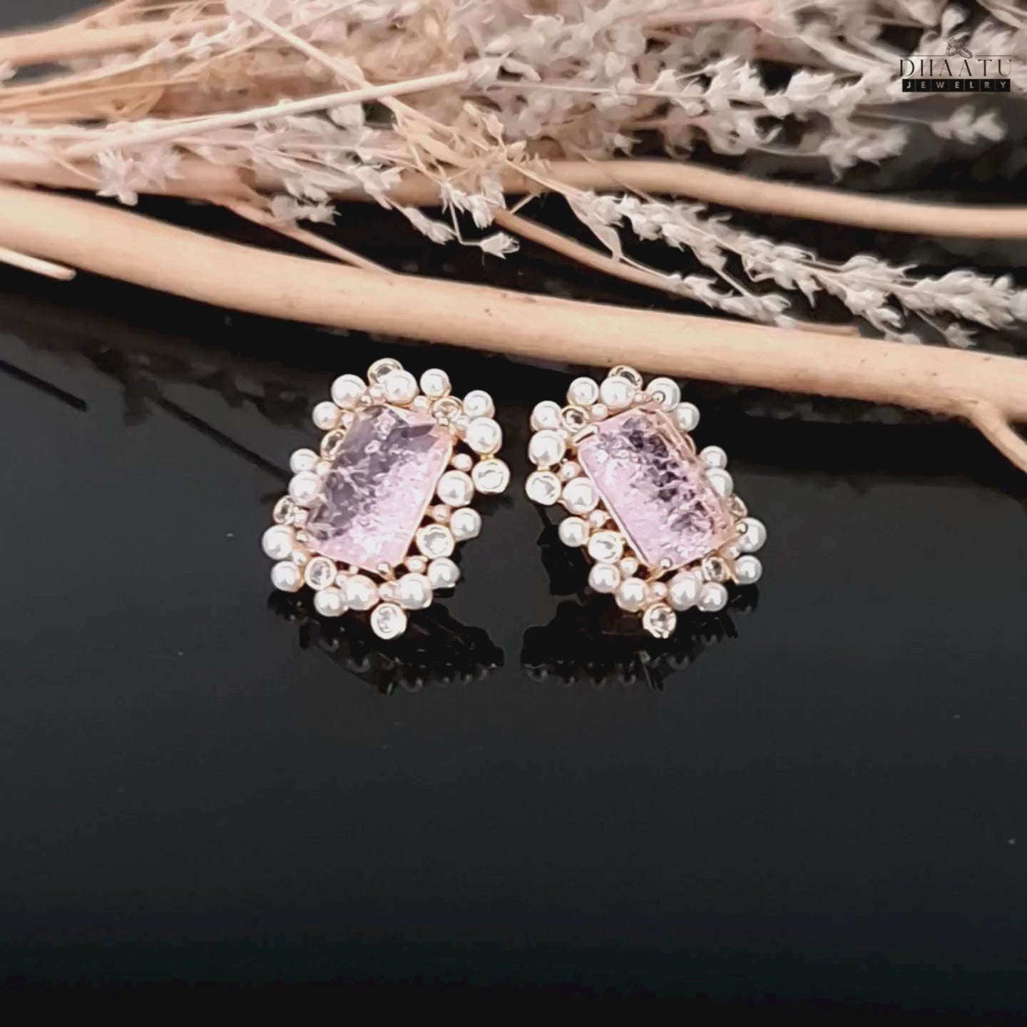 Load video: A video showcasing the DHAATU JEWELRY pink, polki, and pearl stud earrings, highlighting their sparkle and design details.