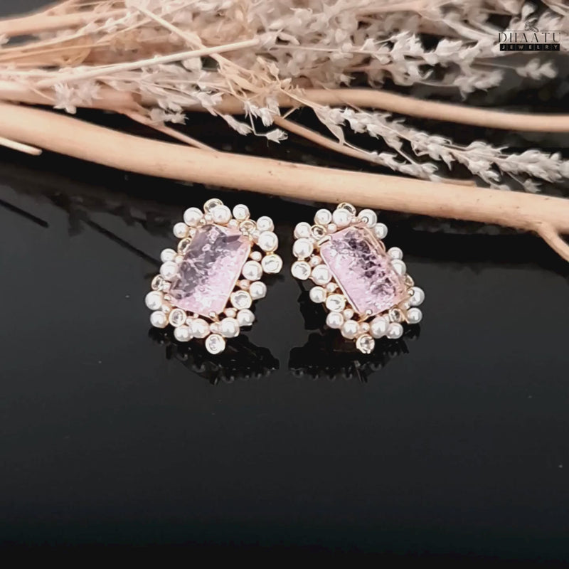 A video showcasing the DHAATU JEWELRY pink, polki, and pearl stud earrings, highlighting their sparkle and design details.