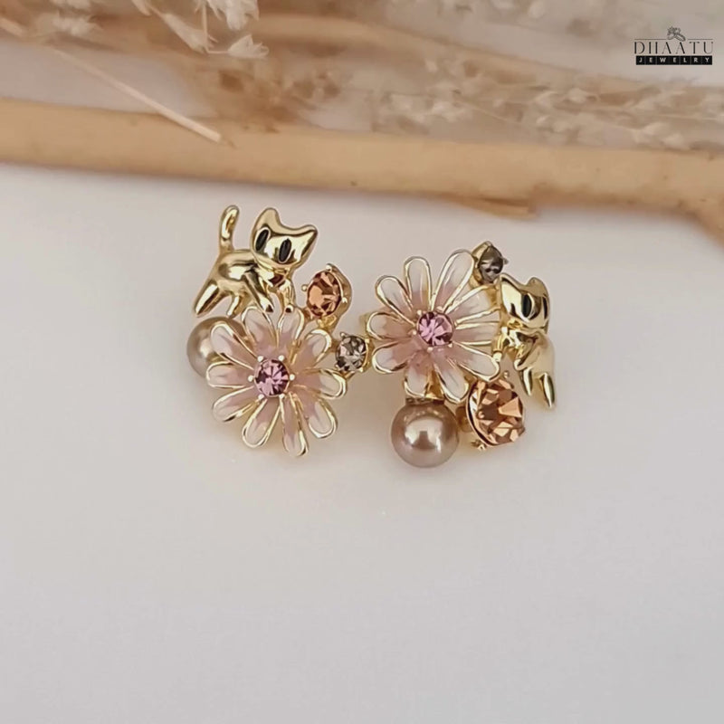 A short video clip showcasing the gold cat and floral earrings from different angles, highlighting their sparkle and detail.