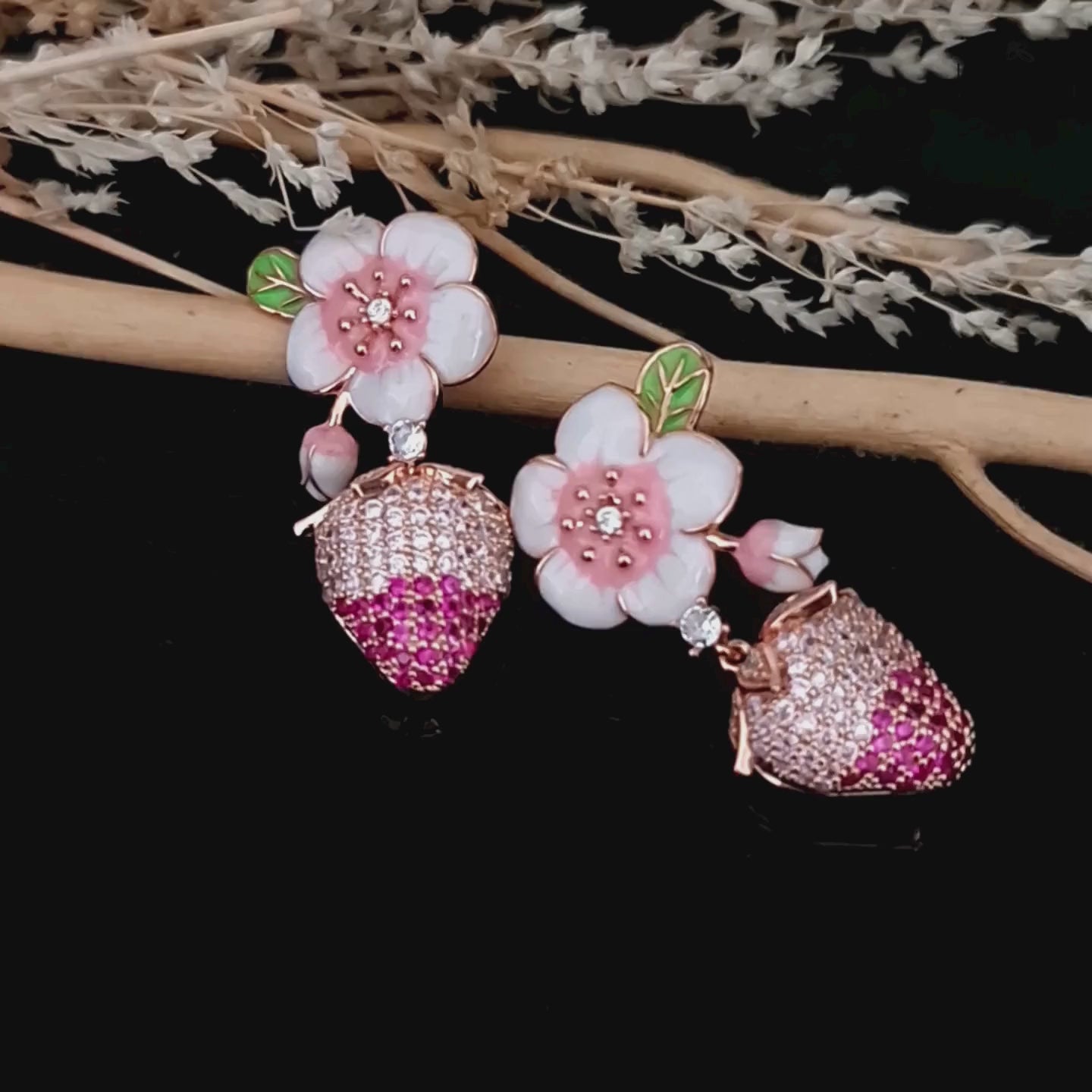 Load video: Product video of rose gold plated pink cz and enamel flower strawberry earrings.
