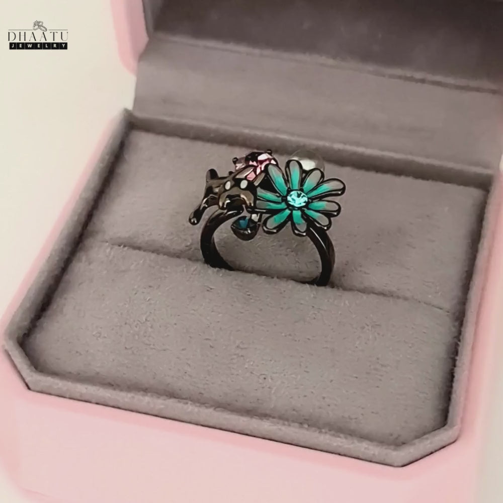 Load video: A video showing the DHAATU JEWELRY cat and floral motif ring resting inside a pink and grey jewelry box, highlighting its elegant presentation.