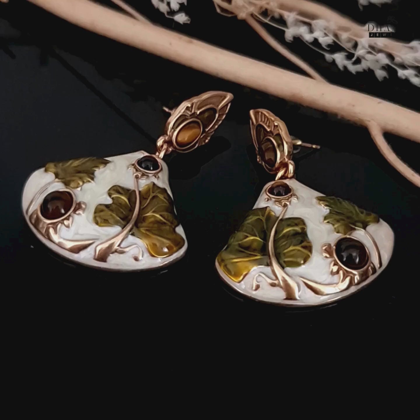 Load video: A 360-degree video of the Art Nouveau lotus drop earrings, showing the intricate enamel work and sparkling tiger&#39;s eye stones from all angles.