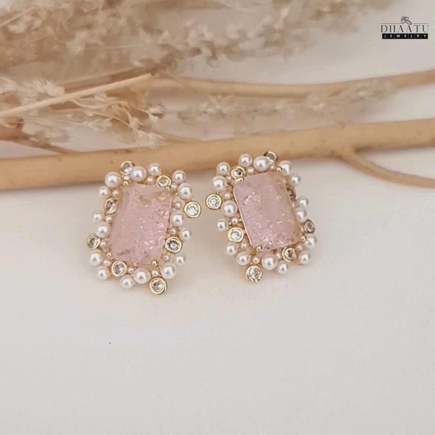 Load video: A video showcasing the DHAATU JEWELRY pink, polki, and pearl stud earrings, highlighting their sparkle and design details.