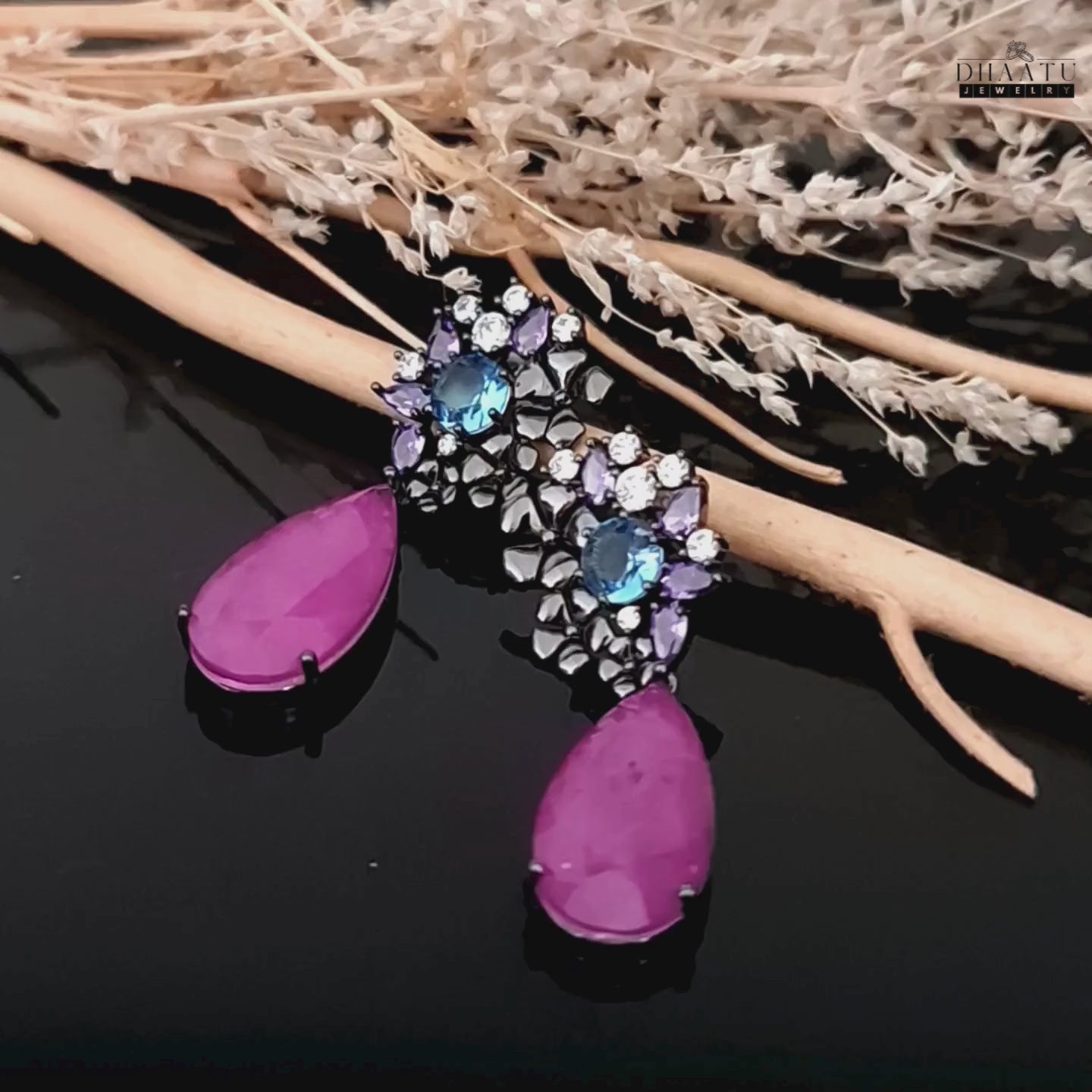 Load video: Product video showcasing the detailed design and sparkling stones of the DHAATU JEWELRY drop earrings.