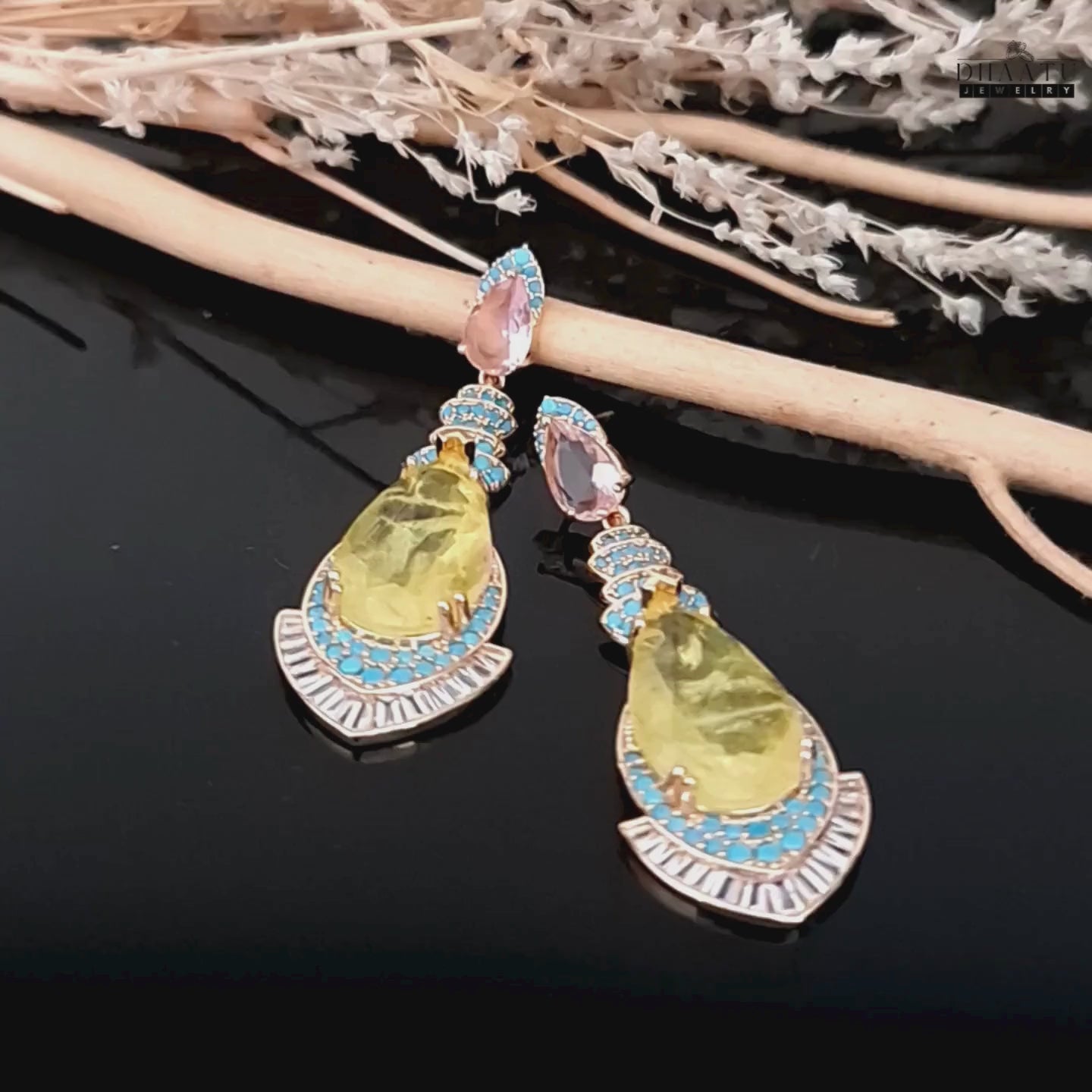 Load video: Video showcasing the intricate details and sparkle of the yellow stone dangle earrings with turquoise and CZ