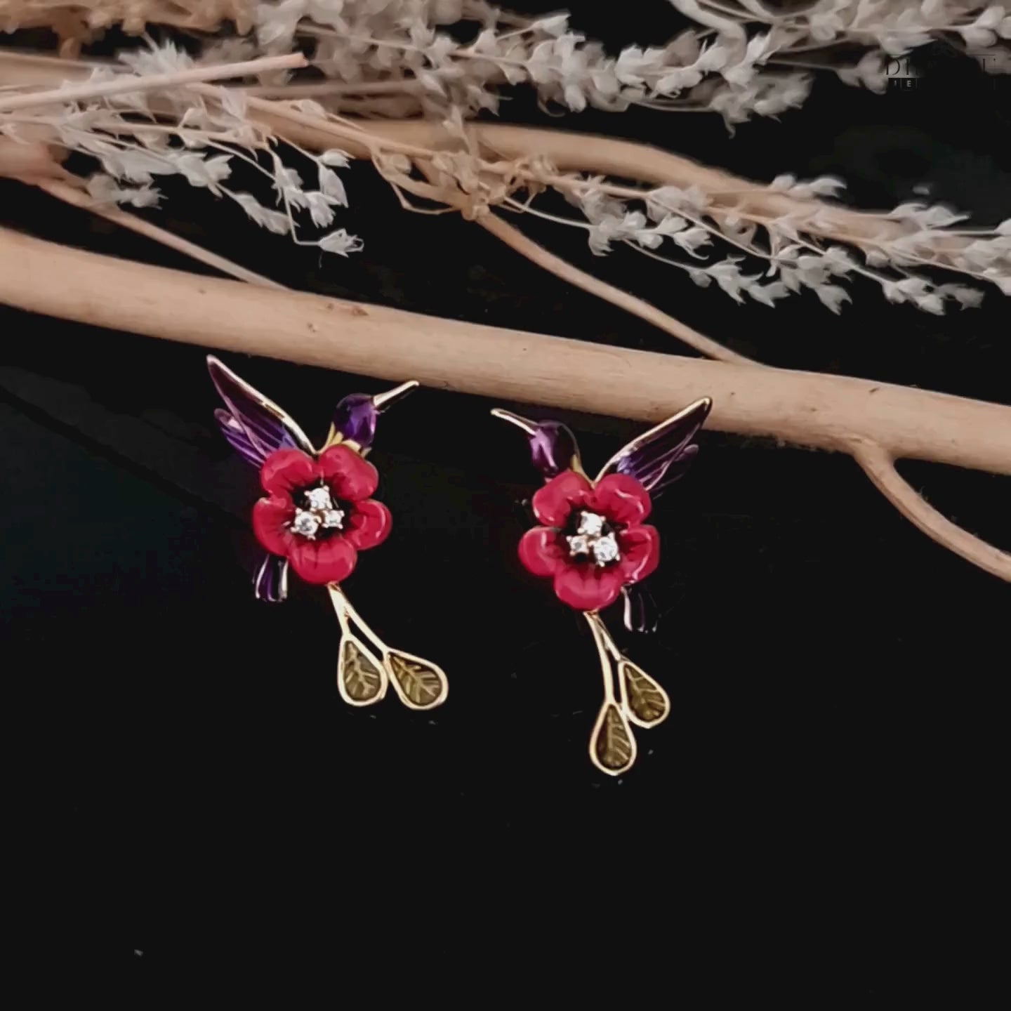 Load video: A video showcasing the red and purple enamel hummingbird earrings, highlighting their design and movement.