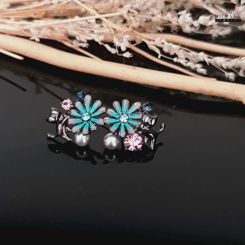 A short video clip of the gunmetal cat and floral earrings, showing their intricate design and luster.