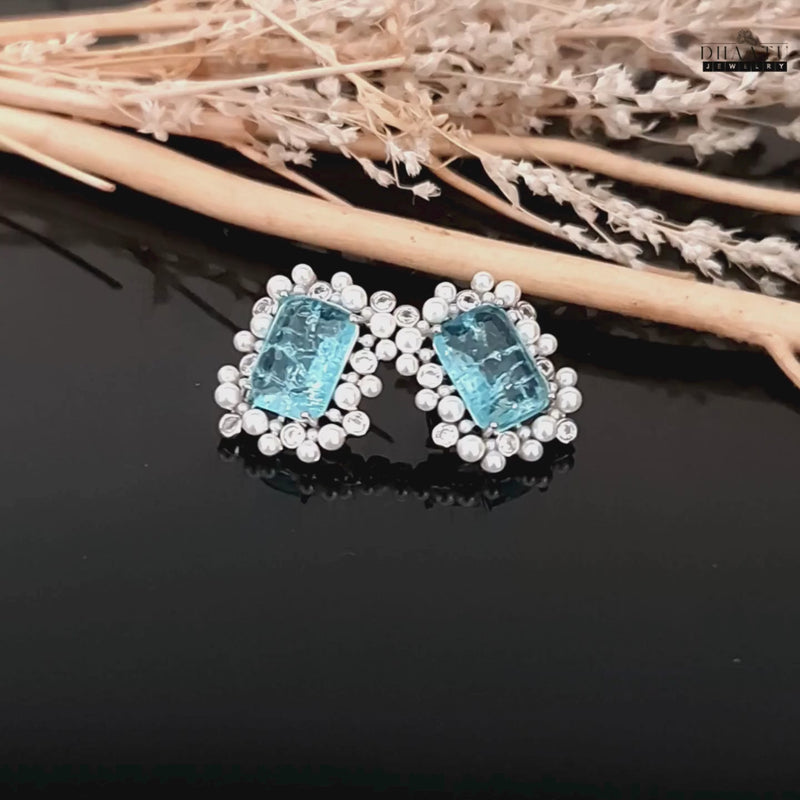 Product video of blue rectangular doublet stone stud earring with pearls and kundan.