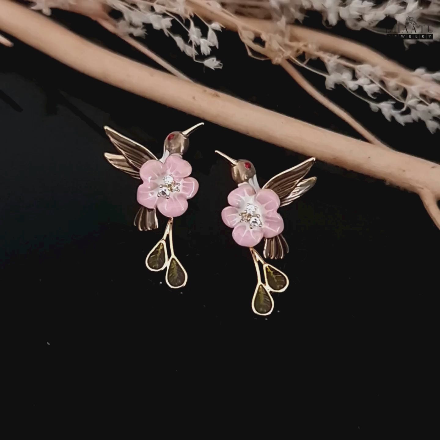 Load video: A video showcasing the pink and brown enamel hummingbird earrings, highlighting their design and sparkle.