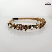 Regal gold and pearl embellished crystal hairband on a clean white background, showcasing intricate details and modern western design