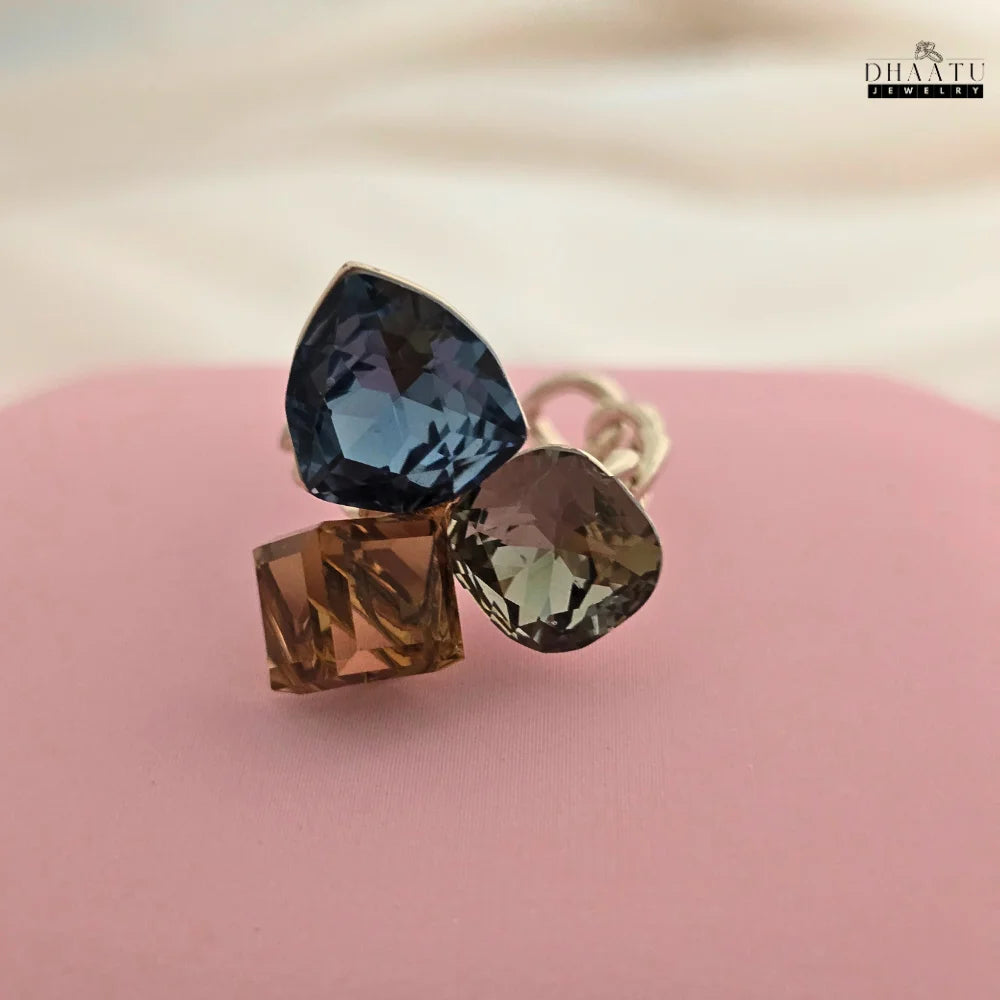 Close-up shot of the rose gold-plated cocktail ring, focusing on the large blue teardrop crystal.
