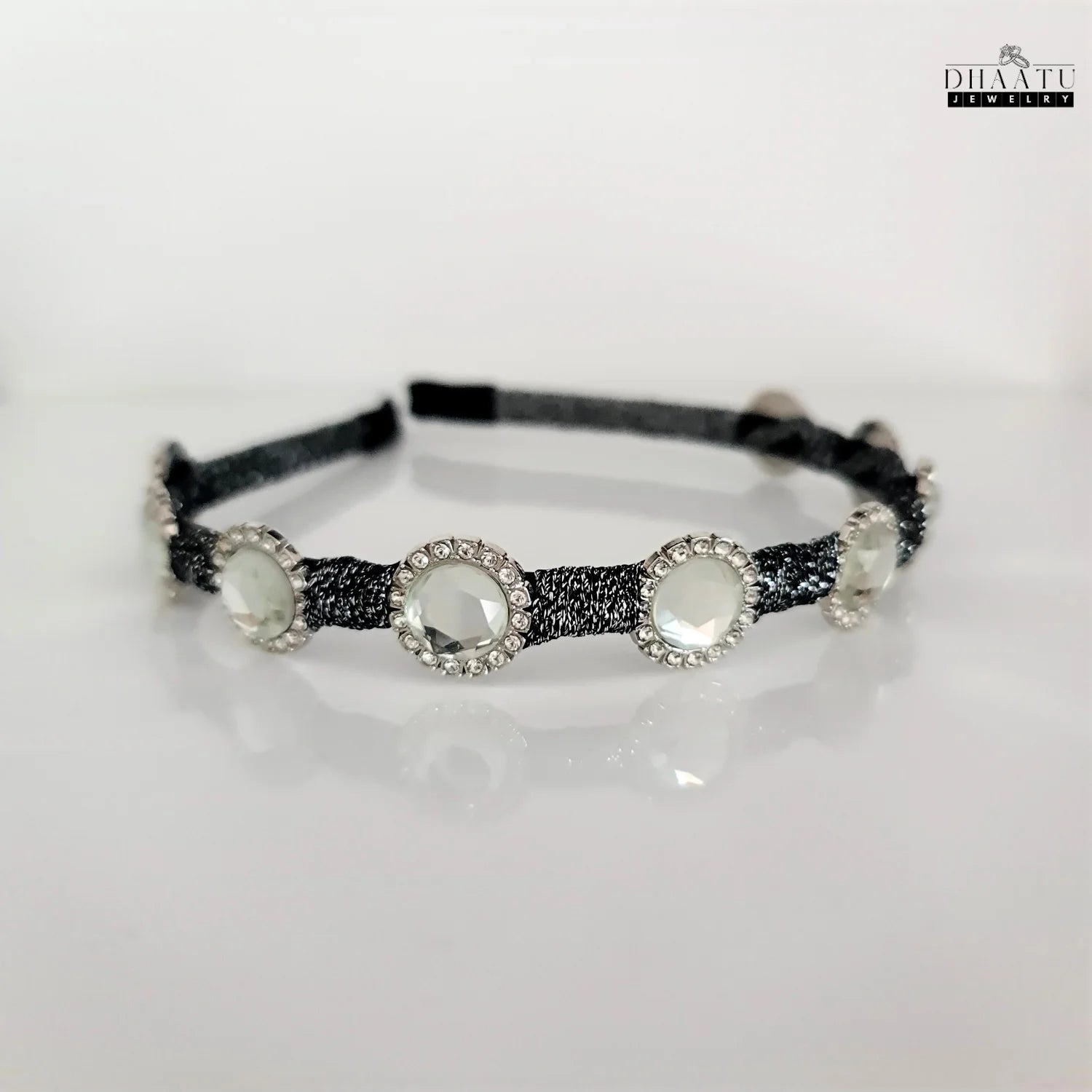 Versatile black braided crystal headband with sparkling clear stones, shown on a bright white background.