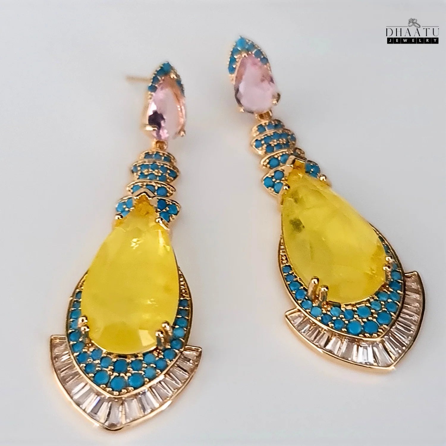 Front view of yellow stone dangle earrings with turquoise and CZ on a clean white background, highlighting their elegant design
